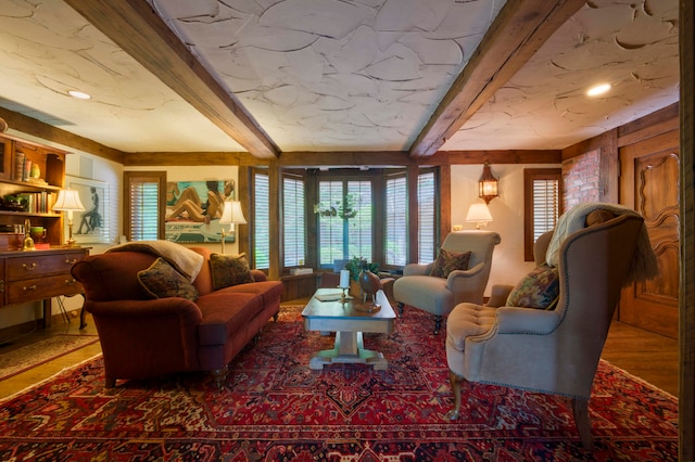 living room with beamed ceiling and plenty of natural light