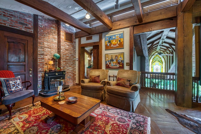 living room featuring beamed ceiling, parquet floors, and brick wall