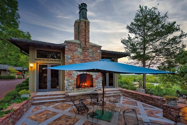 back house at dusk with a patio area