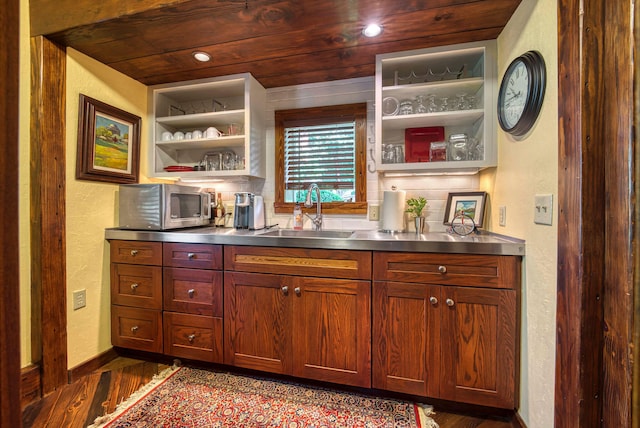 bar with built in features, sink, stainless steel counters, dark hardwood / wood-style floors, and wooden ceiling