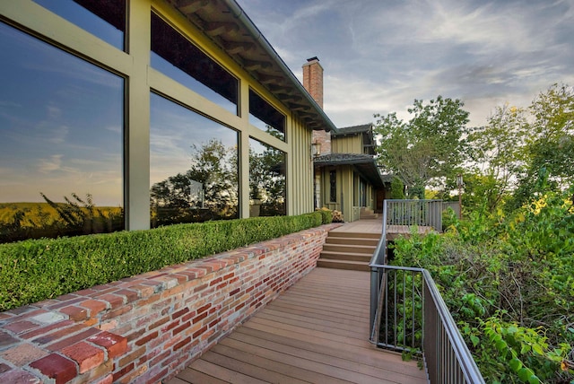 property exterior at dusk with a wooden deck