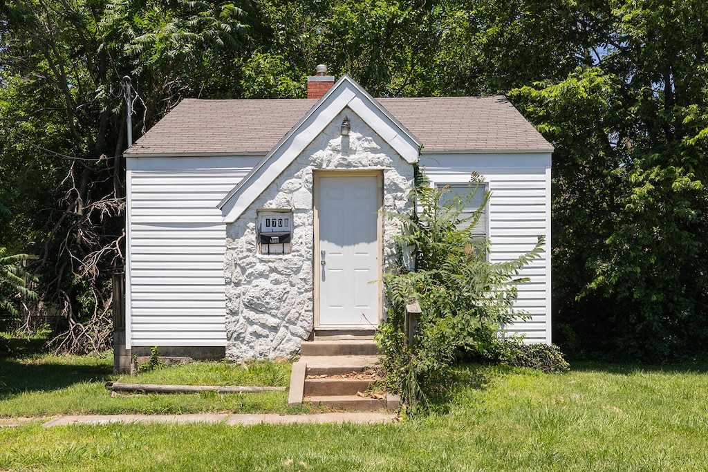 view of outbuilding with a lawn