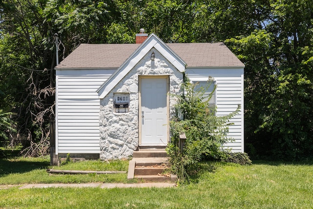 view of outbuilding with a lawn