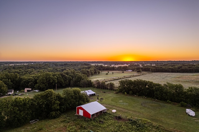 aerial view at dusk featuring a rural view