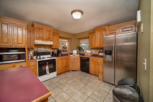 kitchen featuring light tile patterned floors, appliances with stainless steel finishes, and sink