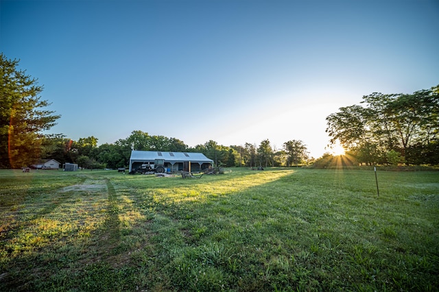 view of yard with a rural view and an outdoor structure