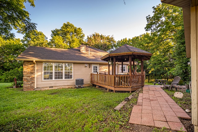 rear view of property with a gazebo, cooling unit, a lawn, and a deck