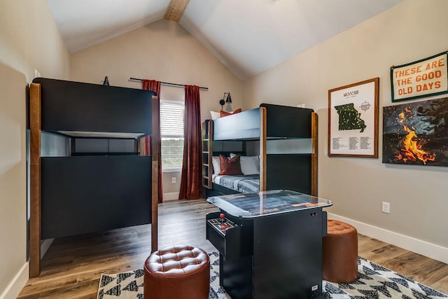 bedroom featuring wood-type flooring and lofted ceiling with beams