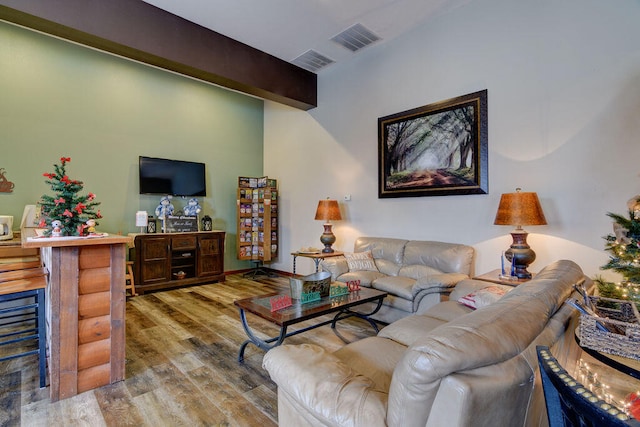 living room with beamed ceiling and hardwood / wood-style floors