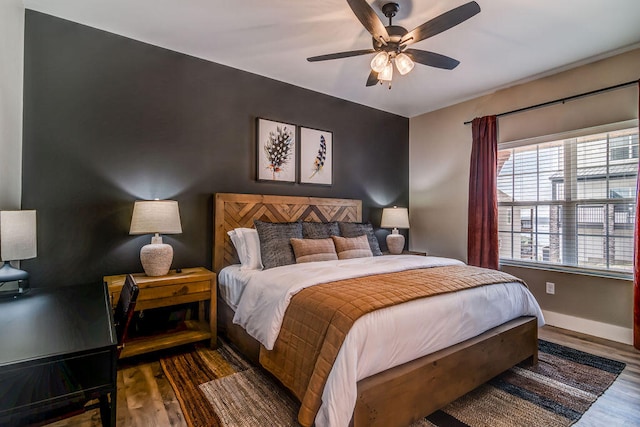 bedroom with ceiling fan and dark hardwood / wood-style floors