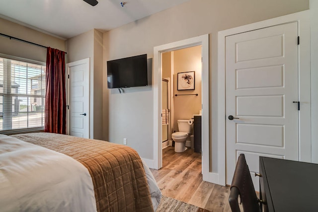 bedroom featuring light hardwood / wood-style flooring and ensuite bath