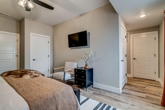 bedroom with light wood-type flooring and ceiling fan