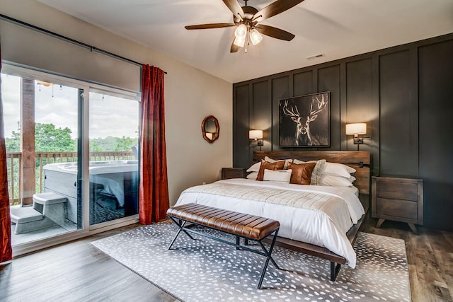 bedroom featuring access to exterior, hardwood / wood-style flooring, and ceiling fan