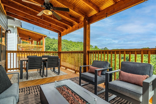 deck with outdoor lounge area and ceiling fan