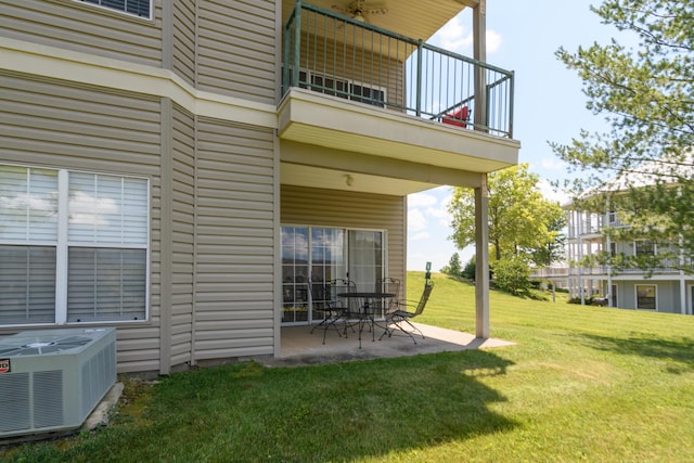exterior space featuring central AC unit, a patio, and a balcony