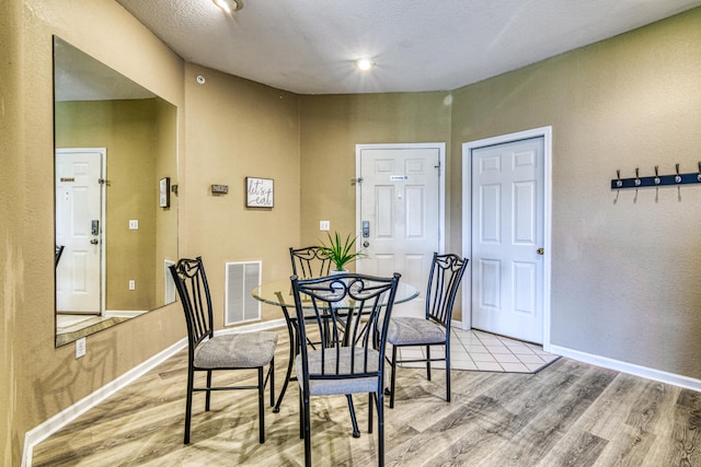 dining area with light hardwood / wood-style floors