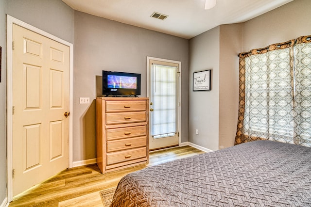 bedroom featuring light wood-type flooring, baseboards, a ceiling fan, and visible vents