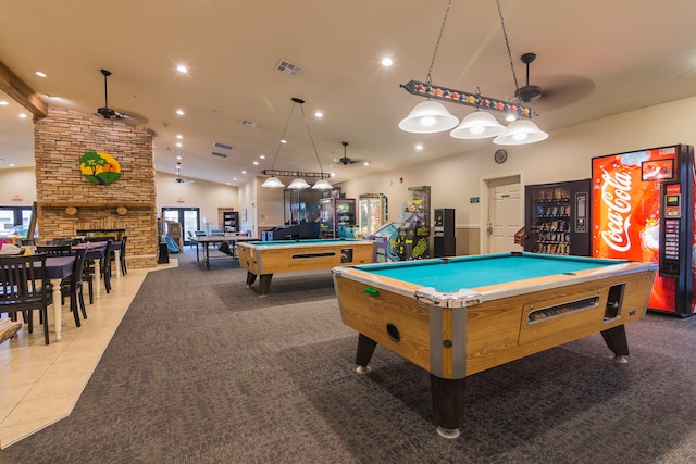 game room featuring vaulted ceiling, light carpet, billiards, and a stone fireplace