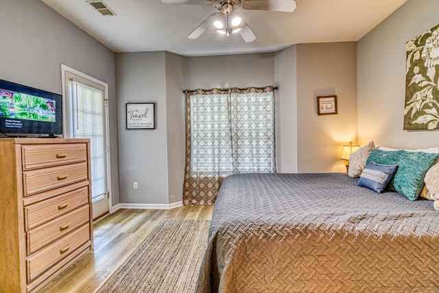 bedroom featuring ceiling fan, baseboards, light wood-style floors, and visible vents