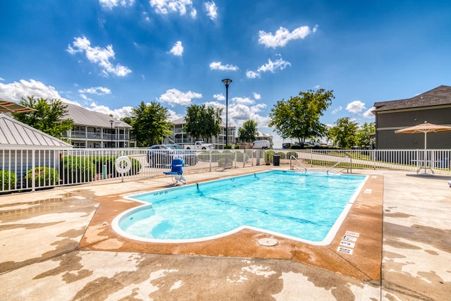 view of swimming pool featuring a patio area