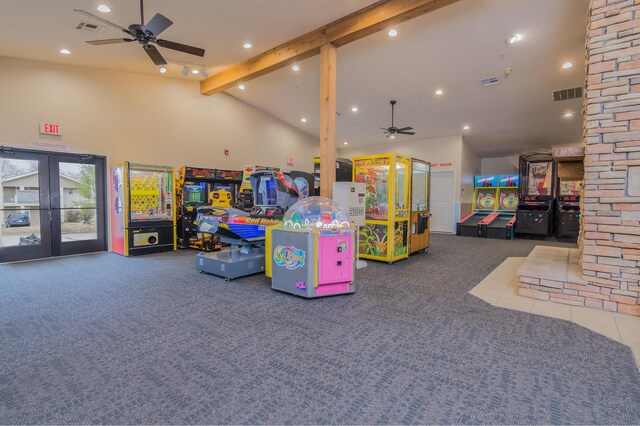 rec room with carpet floors, visible vents, a ceiling fan, and vaulted ceiling with beams
