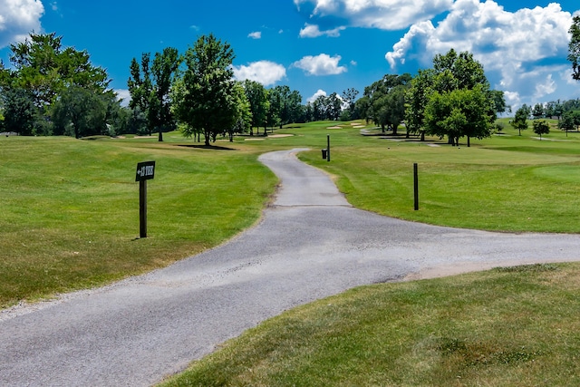 view of home's community featuring a yard and golf course view