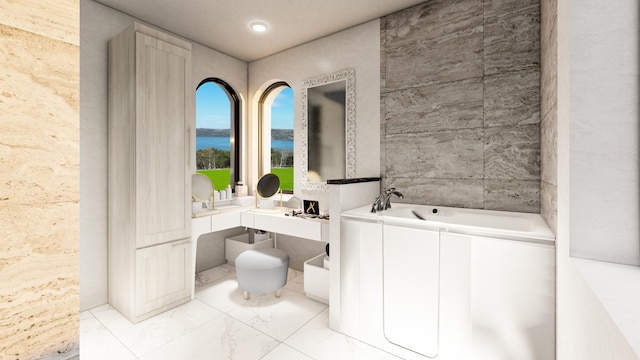 bathroom with a water view, vanity, tile walls, and a washtub