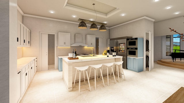 kitchen featuring a kitchen island with sink, a breakfast bar, white cabinets, wall chimney exhaust hood, and appliances with stainless steel finishes