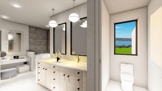 bathroom featuring a water view, vanity, a washtub, and toilet