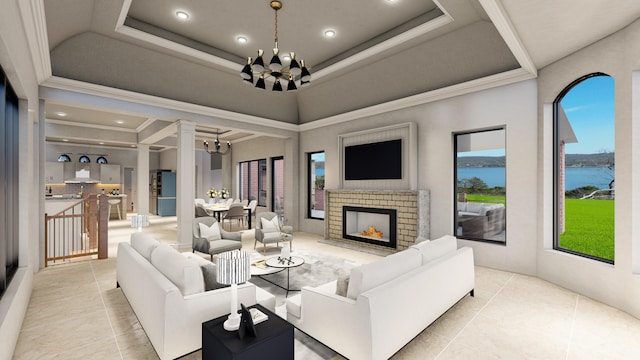 living room with a notable chandelier, a fireplace, crown molding, and light tile patterned flooring