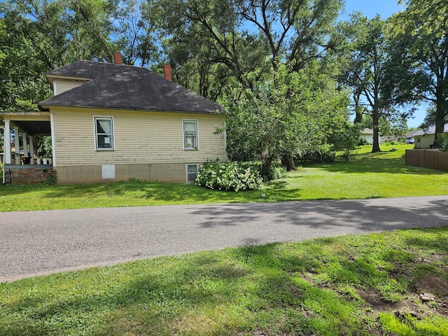 view of side of home featuring a yard