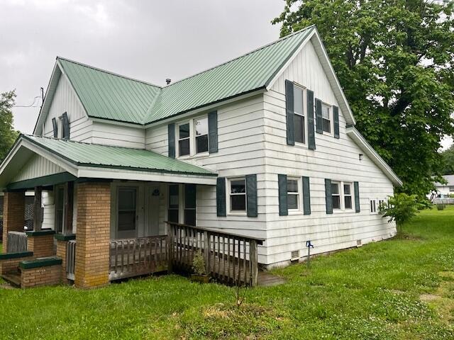 exterior space with a yard and covered porch