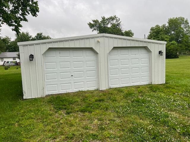 garage featuring a lawn