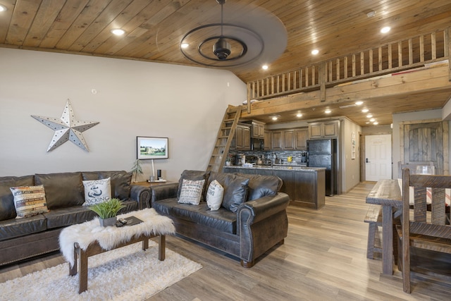 living room with wood ceiling, high vaulted ceiling, and light hardwood / wood-style floors