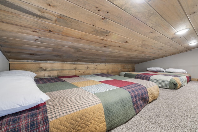 carpeted bedroom with wood ceiling, wooden walls, and vaulted ceiling