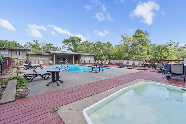 view of swimming pool featuring a wooden deck