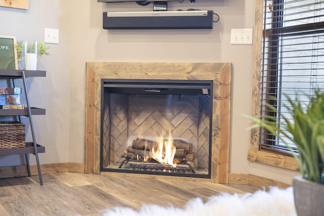 room details featuring a wall mounted air conditioner and hardwood / wood-style floors