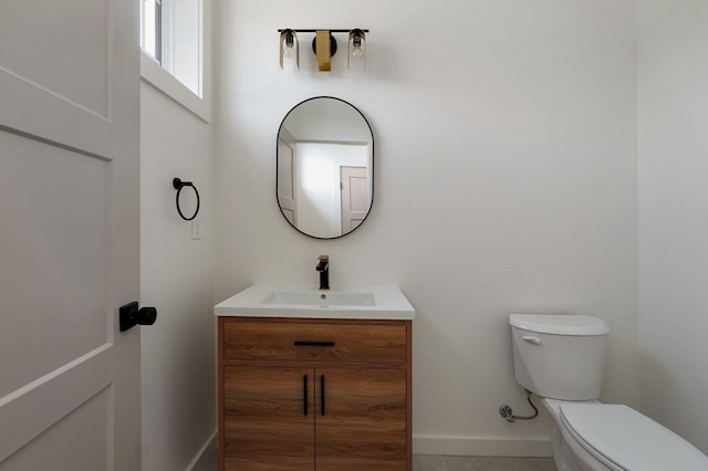 bathroom featuring toilet and vanity