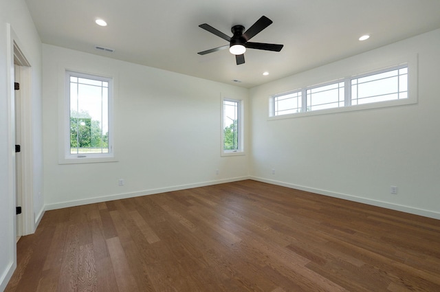 empty room featuring dark wood-type flooring and ceiling fan