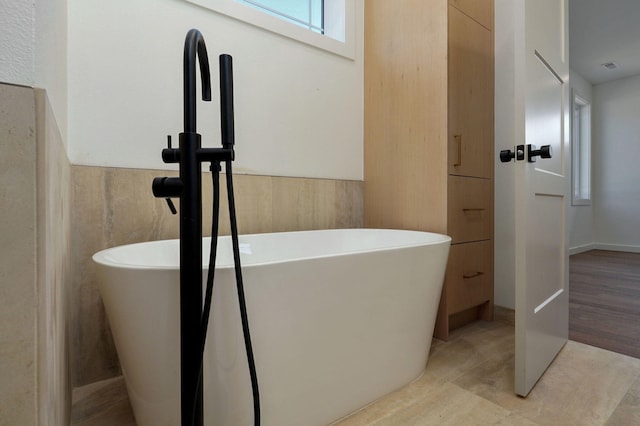 bathroom with a washtub and sink