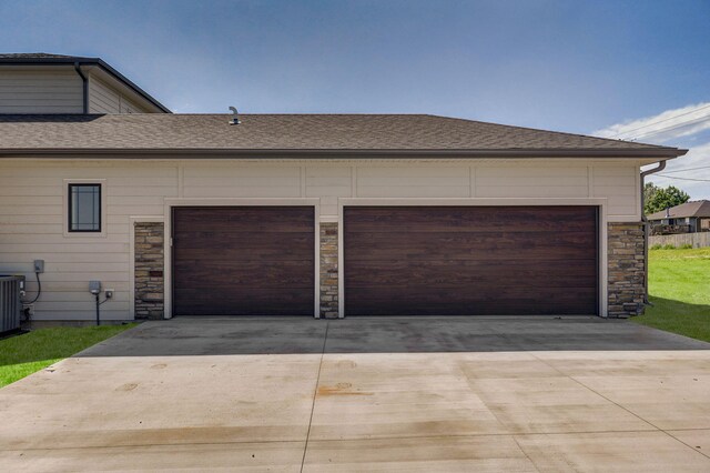 2153 E Will St, Republic, MO 65738 - garage featuring central AC unit and concrete driveway