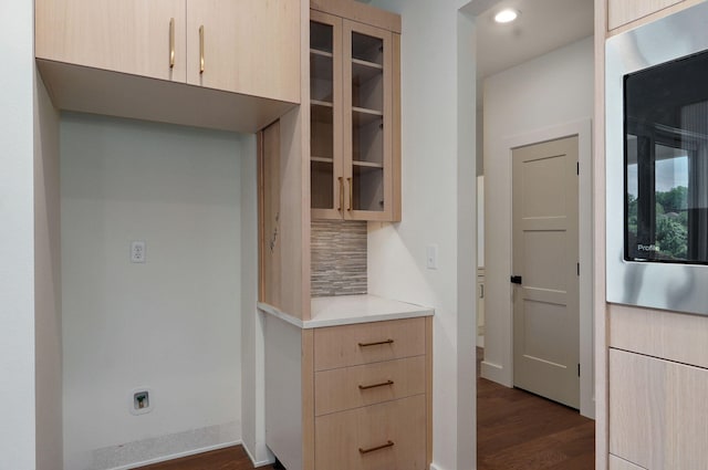 kitchen with decorative backsplash, light brown cabinets, dark hardwood / wood-style floors, and built in microwave