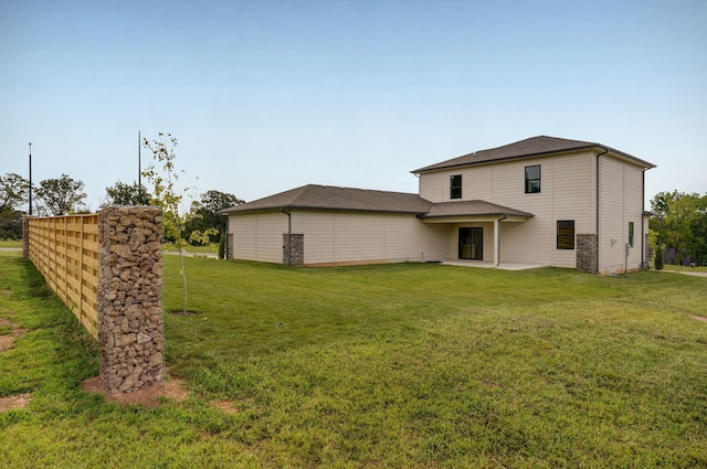 rear view of property with a patio area and a yard