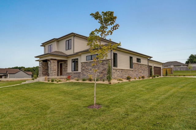 view of front of house featuring a garage and a front yard