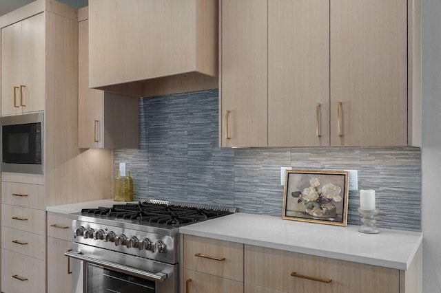 kitchen with high end stove, backsplash, extractor fan, and light brown cabinets