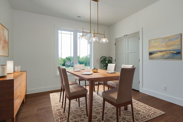 dining space with dark hardwood / wood-style floors