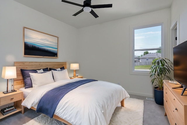 bedroom featuring ceiling fan and light carpet