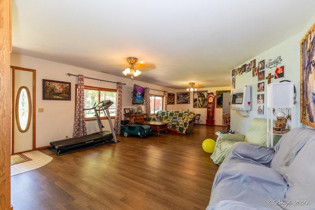 living room with ceiling fan, wood-type flooring, and heating unit