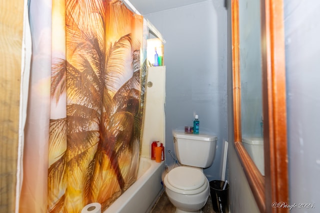 bathroom featuring shower / bath combination with curtain and toilet