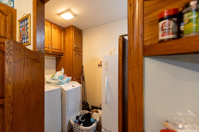 washroom featuring independent washer and dryer and cabinets